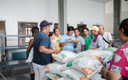 <p><strong>SEEDS TO RECOVERY.</strong> A total of 117 farmers in Tarlac City whose crops were adversely affected by Typhoon Egay receive inbred rice seeds on Wednesday (Aug. 16, 2023) under the Rice Competitiveness Enhancement Fund program. Some 285 sacks of inbred seeds were provided in a bid to help farmers recover from the losses due to weather disturbances. <em>(Photo courtesy of Tarlac City government)</em></p>