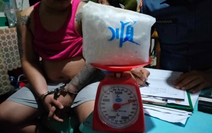 <p><strong>BUSTED.</strong> An anti-illegal drug operative documents the 1 kg. of suspected shabu, valued at PHP 6.8 million, that was seized during a buy-bust in Barangay Calindagan, Dumaguete City at dawn Saturday (Aug. 19, 2023). Two suspected drug pushers were arrested in the same operation. <em>(Photo courtesy of Negros Oriental Police Provincial Office)</em></p>