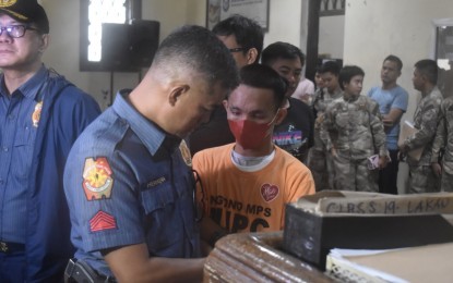 <p><strong>VACATION OVER.</strong> The Angono municipal police prepares New Bilibid Prison inmate Michael Angelo Cataroja before his return to the New Bilibid Prison in Muntinlupa City on Friday (Aug. 18, 2023). The convict went missing on July 15 and was recaptured at his residence in the Rizal province town on Aug. 17.<em> (Courtesy of BuCor)</em></p>