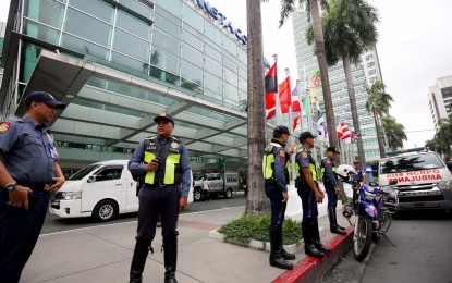 <p><strong>POLICE VISIBILITY.</strong> Cops secure the vicinity of Smart Araneta Coliseum in Cubao, Quezon City on Wednesday (Aug. 23, 2023), one of the venues of the FIBA World Cup. The LRT-2 said athletes, delegates and media covering the event get free rides from Aug. 23-Sept. 12. <em>(PNA photo by Joan Bondoc)</em></p>