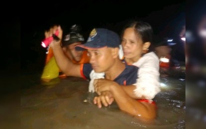 <p><strong>RESCUE.</strong> Personnel of the Bureau of Fire Protection rescues a flood-hit resident of Barangay Pahanocoy in Bacolod City early Monday morning (Aug. 28, 2023). Heavy rains brought by Typhoon Goring flooded at least 12 villages in the city, data from the City Disaster Risk Reduction and Management Office showed. <em>(Photo courtesy of BFP-Bacolod City Fire Station)</em></p>
<p> </p>