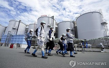 <p><strong>RADIOACTIVE WASTEWATER</strong>. This pool photo, provided by EPA, shows foreign journalists being guided while tanks containing treated radioactive wastewater are seen in the background at the Fukushima Daiichi nuclear power plant in Japan on Aug. 27, 2023. <em>(Yonhap)</em></p>