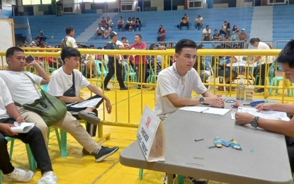 <p><strong>FILING OF COC</strong>. Commission on Elections Dagupan City officer Michael Franks Sarmiento (right) checks the certificate of candidacy form of an aspirant at the People's Astrodome in Dagupan City on Monday (Aug. 28, 2023). Sarmiento warned aspirants to avoid premature campaigning and wait for the start of the campaign period on Oct. 19. <em>(Photo by Liwayway Yparraguirre)</em></p>