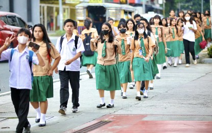 <p><strong>BACK TO SCHOOL</strong>. Students of the Quezon City High School troop back to their school on Scout Ybardolaza Street, Barangay Sacred Heart, Quezon City during the first day of classes on Aug. 29, 2023. The Department of Education said more than 20 million students from public and private schools have enrolled for school year 2023-2024. <em>(PNA photo by Robert Oswald P. Alfiler) </em></p>