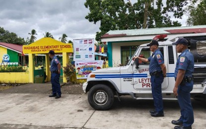 <p><strong>PEACEFUL.</strong> Policemen deployed outside Maghubas Elementary School in Burauen, Leyte secure the class opening on Tuesday (Aug. 29, 2023). The Department of Education continues to monitor the campus due to a land ownership dispute. (<em>PNA photo by Sarwell Meniano</em>)</p>