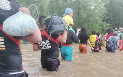 <p><strong>FLOOD RESCUE</strong>. Personnel of the Bureau of Fire Protection rescue trapped residents in a flood-hit area in San Enrique, Negros Occidental on Aug. 28, 2023. As of 11 a.m. Wednesday (Aug. 30), some 100,334 Negrenses have been affected by floods and rains brought by southwest monsoon enhanced by Typhoon Goring for four days now, data from the provincial government showed. <em>(Photo courtesy of BFP-San Enrique, Negros Occidental Fire Station)</em></p>
