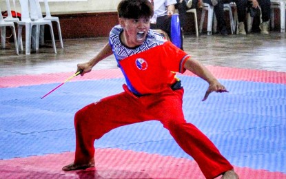 <p><strong>GOLD WINNER.</strong> Walter Sam Jr. of Mindanao State University–Iligan Institute of Technology displays his brilliant form in the men's non-traditional single weapon Anyo (form) event of the arnis competition in the 2023 Reserve Officers' Training Corps (ROTC) Games Mindanao leg at the Western Mindanao State University (WMSU) Gym in Zamboanga City on Wednesday (Aug. 30, 2023). Sam won the gold medal. <em>(Photo courtesy of the Philippine Sports Commission)</em></p>