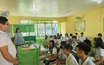 <p><strong>OPENING OF CLASSES</strong>. Department of Education (DepEd) Schools Division of Antique information officer Eric Cortejo (left) monitors the opening of classes at the Aureliana National High School in Patnongon, Antique on Thursday (Aug. 31, 2023). Cortejo in an interview said classes in all 537 public schools in Antique have already resumed. (<em>PNA courtesy of DepEd Antique</em>)</p>