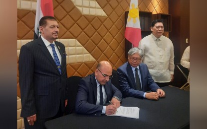 <p><strong>PH-IRAQ PARTNERSHIP</strong>. Federation of Iraqi Chambers of Commerce (FICC) president Heider Jasim (seated left) and Pampanga Chamber of Commerce and Industry Inc. (PamCham) director Paulino Yusi (seated right) lead the signing of a memorandum of understanding between their business groups at the Manila Diamond Hotel in Pasay City on Aug. 30, 2023. Embassy of Iraq in Manila Chargé d'Affaires Dr. Khalid Ibrahim Mohammed (left) and Department of Foreign Affairs Assistant Secretary Mardomel Celo Melicor (right) witnessed the signing of the MOU.<em> (PNA photo by Kris M. Crismundo)</em></p>