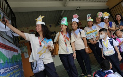 <p><strong>CAREER PROGRESSION.</strong> Teachers of President Corazon C. Aquino Elementary School in Quezon City gather on the first day of classes on Aug. 29, 2023. During the hybrid post-State of the Nation Address (SONA) forum on Wednesday (July 24, 2024), Education Secretary Juan Edgardo "Sonny" Angara said the Department of Education is now coordinating with three other government agencies to realize the career progression of public school teachers in the country. <em>(PNA file photos by Joan Bondoc)</em></p>