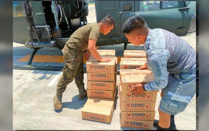 <p><strong>AIRLIFT.</strong> Philippine Air Force personnel load family food packs from the Department of Social Welfare and Development in a PAF chopper in Mactan Air Base in Lapu-Lapu City, Cebu in this undated photo. The PAF in Central Visayas is actively helping the DSWD in transporting much-needed food packs to flood-hit areas in Negros Occidental. <em>(Photo courtesy of DSWD)</em></p>