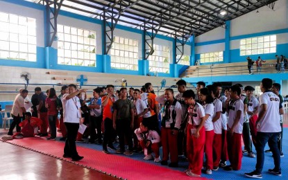 <p><strong>PODIUM FINISHERS</strong>. Medalists in the arnis competition of the 1st Philippine Reserve Officers' Training Corps (ROTC) Games Mindanao leg prepare for the awarding ceremony at the Western Mindanao State University (WMSU) Gym in Zamboanga City on Friday (Sept. 1, 2023). The gold medalists in each event earn automatic slots in the National Championships. <em>(Photo courtesy of Philippine Sports Commission)</em></p>