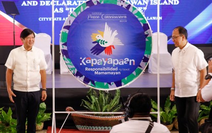 <p class="p1"><strong>SOUND OF PEACE.</strong> President Ferdinand R. Marcos Jr. (left) and Presidential Adviser on Peace, Reconciliation and Unity Secretary Carlito Galvez Jr. pose with the Peace Gong in Puerto Princesa City on Friday (Sept. 1, 2023) as Palawan Island is officially declared insurgency-free. The gong symbolizes the start of National Peace Consciousness Month.<em> (PNA photo by Rey Baniquet)</em></p>
