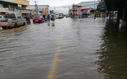 <p><strong>STATE OF CALAMITY.</strong> Motorists and pedestrians wade through flooded streets in the municipality of Oton on Aug. 29, 2023. Oton’s municipal council declared a state of calamity in a special session on Friday (Sept. 1, 2023) due to the onslaught of Typhoon Goring and the southwest monsoon. <em>(Photo courtesy of Oton Vice Mayor Jose Neil Olivarez FB page)</em></p>