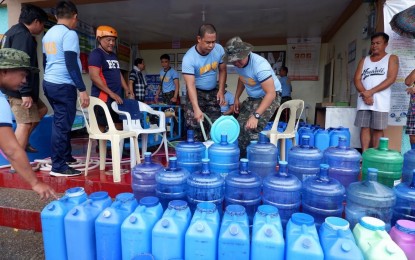 <p><strong>ISOLATED.</strong> Residents of Barangay Nalasin, Solsona, Ilocos Norte line up their water containers to get potable water in this undated photo. The village has been isolated for almost a week now due to severely damaged access roads and embankment that disconnected them from the town proper. <em>(Photo courtesy of Municipal Government of Solsona)</em></p>