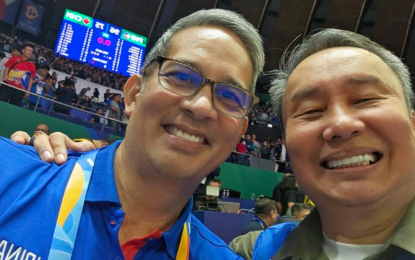 <p><strong>SELFIE.</strong> Philippine Olympic Committee President Abraham “Bambol” Tolentino and First Vice Al Panlilio pose with the electronic scoreboard in the background showing the final score of the Philippines-China game at the Smart Araneta Coliseum on Sept. 2, 2023. Tolentino heads the cycling federation while Panlilio is the basketball association president. <em>(Photo courtesy of POC)</em></p>