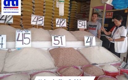 <p><strong>PRICE MONITORING.</strong> A personnel of the Department of Trade and Industry (DTI) checks the rice prices in a market in Valencia City, Bukidnon. The Police Regional Office in Northern Mindanao on Wednesday (Sept. 6, 2023) committed to help other agencies like DTI in the awareness drive on the newly imposed Executive Order No. 39, which set a price ceiling on rice prices. <em>(Photo courtesy of DTI-10)</em></p>