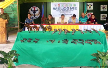 <p><strong>LOOSE FIREARMS.</strong> Lt. Col. Rey Rico, the Army’s 34th Infantry Battalion commander (at the podium), presents the firearms surrendered by village officials to military and local officials Tuesday (Sept. 5, 2023) in Midsayap, North Cotabato. The guns were turned in by 13 village officials from Midsayap and its neighboring town of Aleosan who wanted to help the government's campaign for a peaceful and orderly Barangay and Sangguniang Kabataan elections in October. <em>(Photo courtesy of 6ID)</em></p>