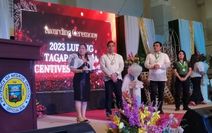 <p><strong>RECOGNIZED.</strong> The Department of the Interior and Local Government (DILG) leads the awarding ceremony for the Negros Oriental Outstanding Barangay Peace and Order Committees, Barangay Tanod Teams, Barangay Anti-Drug Abuse Councils, and Lupong Tagapamayapa Incentives Awards on Thursday (Sept. 7, 2023). DILG 7 (Central Visayas) Director Leocadio Trovela (2nd from left) graced the activity. <em>(PNA photo by Judy Flores Partlow)</em></p>