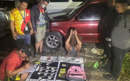 <p><strong>STING OP.</strong> Manuel Ace Delgado Causing, 21, looks on as the police conduct an on-site inventory of the suspected shabu packs worth PHP8.8 million seized during a sting operation in Barangay Poblacion Pardo, Cebu City before dawn on Friday (Sept. 7, 2023). The police said Causing's arrest is expected to reduce by 30 percent the illegal drug activities in the southern village of Cebu City. <em>(Photo courtesy of Arnold Bustamante)</em></p>