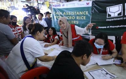 <p><strong>ASSISTANCE.</strong> Personnel of the Department of Social Welfare and Development implement the first batch of cash aid disbursement of PHP15,000 to rice retailers affected by Executive Order 39 or the rice price ceiling at Agora Market in San Juan City on Saturday (Sept. 9, 2023). A total of 48 registered small rice retailers received the assistance. <em>(PNA photo by Joey O. Razon)</em></p>