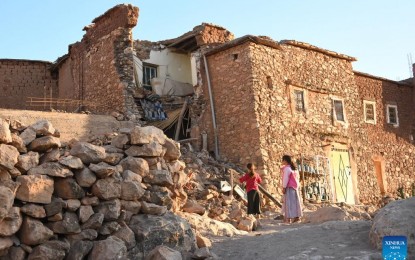 <p>DEADLY QUAKE. Children stand by a damaged building after a 6.8-magnitude earthquake in Tahannaout, Morocco on Sept. 9, 2023. The quake has claimed the lives of 2,012 people and injured 2,059, with 1,404 of them in serious condition, according to the latest update from the country's Interior Ministry on Saturday.<em> (Photo by Saouri Aissa/Xinhua)</em></p>