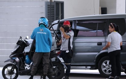 <p><strong>GAS UP.</strong> A gasoline station employee attends to a motorist and a motorcycle rider at a station along East Avenue in Quezon City on Sept. 11, 2023. The Land Transportation Franchising and Regulatory Board (LTFRB) on Tuesday (Sept. 12, 2023) said the distribution of the government’s fuel subsidy program to drivers and operators of public utility vehicles would start on Wednesday (Sept. 13). <em>(PNA photo by Joey O. Razon)</em></p>