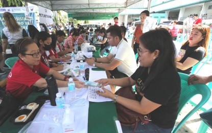 <p><strong>GOV’T AID</strong>. Department of Social Welfare and Development staff members validate documents before handing over PHP15,000 to each qualified micro rice retailer at the Parañaque City Hall on Monday (Sept. 11, 2023). Executive Order 39 imposes a price cap of PHP45 per kg. on well-milled rice and PHP41 per kg. on regular milled rice, thus President Ferdinand R. Marcos Jr.’s order to distribute financial aid to cushion the impact of the temporary price adjustment. <em>(PNA photo by Avito Dalan)</em></p>