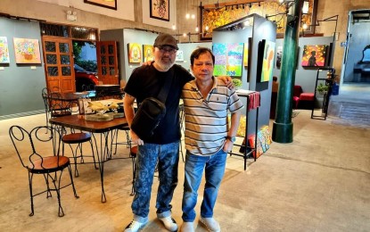 <p><strong>TWO-MAN EXHIBIT</strong>. Filipino artists Roland Rosacay (right) and Chito Mendoza (left) mount a two-man free art exhibition at a coffee and classic cuisine restaurant in Amadeo, Cavite on Sunday (Sept. 3, 2023). Both local artists expressed delight as more Filipinos and leaders realized support for creative Industries. <em>(Photo courtesy: Chito Mendoza)</em></p>