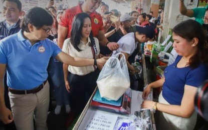 <p><strong>RICE PRICE CAP.</strong> Interior Secretary Benjamin Abalos Jr. (left) leads the inspection of a rice stall in Quezon City on Sept. 5, 2023. The DILG chief on Wednesday (Sept. 13, 2023) called on local government units to enact ordinances that would help ease the burden of rice retailers affected by the price ceiling mandated by Executive Order 39. <em>(Photo courtesy of DILG)</em></p>