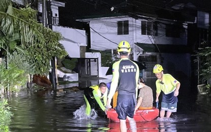 <p><strong>CEBU FLOODING.</strong> Rescuers from the Mandaue City Disaster Risk Reduction and Management Office use rubber boats in rescuing residents of Sto. Niño Village in Barangay Banilad, Cebu City on Wednesday night (Sept. 13, 2023) as houses submerged in flood water. PAGASA-Mactan weather specialist Ann Dumdum said the torrential rain in Metro Cebu on Wednesday and Thursday was brought by the combination of low pressure area and southwest monsoon or Habagat. <em>(Photo courtesy of Mandaue City DRRMO)</em></p>