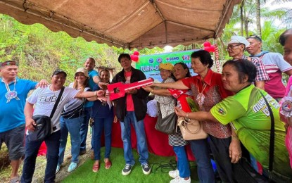 <p><strong>FARM-TO-MARKET ROAD.</strong> Officials of the Department of Social Welfare and Development (DSWD) 12 (Soccsksargen) and residents of remote Barangay Taluya, Glan, Sarangani pose after the turnover ceremony of the PHP1.15 million farm-to-market road that would benefit 130 families, on Wednesday (Sept. 13, 2023). The road was built through the DSWD’s Kapit-Bisig Laban sa Kahirapan - Comprehensive and Integrated Delivery of Social Services (KALAHI-CIDSS) Disaster Response Operations Modality. <em>(Photo courtesy of DSWD-12)</em></p>