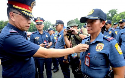 <p><strong>BODY CAMERAS.</strong> QCPD director Brig. Gen. Redrico Maranan fits a body-worn camera to a female police officer at the QCPD headquarters at Camp Karingal, Quezon City on Thursday (Sept. 14, 2023). A total of 179 body-worn cameras from the city government were provided to police officers who would be deployed in 107 polling centers during the Oct. 30 polls. <em>(PNA photo by Joey Razon)</em></p>