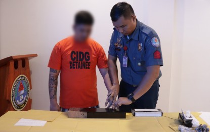 <p><strong>ARRESTED.</strong> One of the suspects in the kidnapping of missing "sabungeros" undergo booking procedures at the CIDG headquarters in Camp Crame on Friday (Sept. 15, 2023). The CIDG-Calabarzon nabbed six accused in two separate locations in Parañaque City. <em>(Photo courtesy of PNP PIO)</em></p>