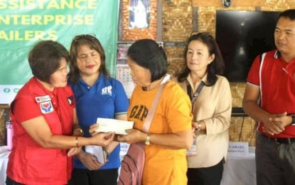 <p><strong>CASH AID.</strong> A rice retailer in Samar receives cash assistance from the Department of Social Welfare and Development (DSWD) in this Sept. 14, 2023 photo. The DSWD has already distributed PHP15,000 cash assistance to 63 small rice retailers in Eastern Samar badly affected by the price cap set by the government. <em>(Photo courtesy of DSWD Eastern Visayas)</em></p>