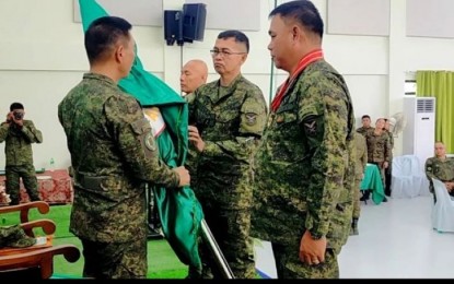 <p><strong>NEW COMMANDER</strong>. Lt. Gen. Roy Galido, commanding general of the Philippine Army (left), hands over the command flag to the new 10th Infantry Division commander, Brig. Gen. Allan Hambala (center), during the change of command ceremony held at the Agila Hall, Camp Gen. Manuel T. Yan Sr. in Mawab, Davao de Oro on Friday (Sept. 15, 2023). With them is outgoing 10ID commander, Maj. Gen. Jose Eriel Niembra (right).<em> (PNA photo by Robinson Niñal Jr.)</em></p>