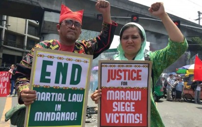 <p><strong>KILLED IN ENCOUNTER.</strong> Kerlan Fanagel (left) poses with a member of the Indigenous Peoples community during one of their mass protests at the height of the Martial Law declaration in Mindanao, in this undated photo. The Visayas Command said on Saturday (Sept. 16, 2023) that Fanagel was one of the six members of the New People's Army killed in the encounter in Bilar, Bohol on Sept. 7.<em> (Photo courtesy of Viscom PIO)</em></p>