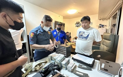 <p><strong>APPREHENDED</strong>. Southern Police operatives do te inventory of the evidence seized after the serving of a search warrant.  Arrested during the operation was a Chinese national identified as Xiao Ji (right in white shirt) who allegedly operating a prostitution ring in Paranaque City.  (<em>Photo courtesy of SPD)</em></p>