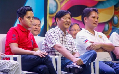 <p><strong>GUEST OF HONOR</strong>. President Ferdinand R. Marcos Jr. (center) witnesses the MassKara Festival street and arena dance competition at Paglaum Sports Complex in October last year, with Bacolod City Mayor Alfredo Abelardo Benitez (right), Ilocos Norte 1st District Rep. Sandro Marcos (left), Negros Occidental Vice Governor Jeffrey Ferrer (2nd row, left) and 3rd District Rep. Jose Franciso Benitez. On Monday (Sept. 18, 2023), Benitez said the Chief Executive and First Lady Liza Araneta-Marcos will once again come for the highlights of this year’s festival slated on Oct. 7 to 22. (<em>File photo courtesy of Department of Tourism</em>)</p>