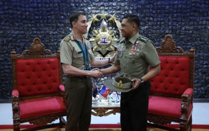 <p><strong>BOOSTING TIES.</strong> Armed Forces of the Philippines (AFP) chief. Gen. Romeo Brawner Jr. (right) receives a memento from Australian Army chief Lt. Gen. Simon Stuart who paid a courtesy visit to the AFP General Headquarters on Monday (Sept. 18, 2023). Among areas of cooperation tackled by the two officials are bilateral military partnerships, including training, student exchanges, reservist development, non-commissioned officer empowerment, and recruitment. <em>(Photo courtesy of the AFP)</em></p>
