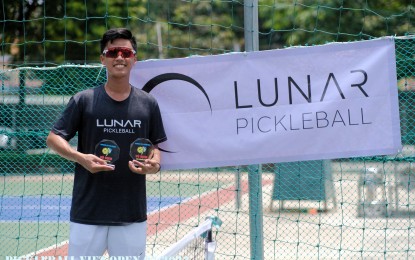 <p><strong>CHAMPION.</strong> Leander Lazaro holds the trophies he won at the Vietnam Open last July. He is set to compete in the World Pickleball Championship from Sept. 19 to 24, 2023 in Bali, Indonesia. <em>(Contributed photo)</em></p>