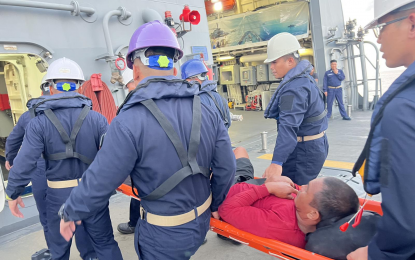 <p><strong>SURVIVOR.</strong> Fisherman Sonny Agting is seen in this photo taken on Monday (Sept. 18, 2023) as he was being carried by the crew of BRP Antonio Luna on his way to a Palawan hospital. He was later declared in stable condition. <em>(Photo courtesy of the Western Command)</em></p>