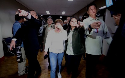 <p><strong>DETAINED.</strong> Personnel of the Senate's Office of the Sergeant at Arms escort France Garcia Ruiz (in denim pants) after being cited in contempt by the Senate Committee on Justice and Human Rights on Tuesday (Sept. 19, 2023). Ruiz is the former employer of household helper Elvira Vergara who was allegedly abused for years in Oriental Mindoro. <em>(PNA photo by Avito Dalan)</em></p>