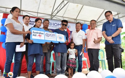 <p><strong>HOUSING BENEFICIARIES.</strong> Three residents of Pio Duran town in Albay receive the key symbol for their disaster-proof 'safe room' constructed through the International Organization for Migration (IOM) Philippines and the Australian government, in partnership with the provincial government of Albay during a turnover ceremony on Monday (Sept. 18, 2023). Each house can accommodate up to 35 people based on the simulation done by IOM. <em>(Photo courtesy of Albay Provincial Information Office)</em></p>