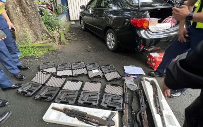 <p><strong>INTERCEPTED.</strong> A man yields 15 firearms during an inspection at the Gate 2 of Camp Crame, Quezon City on Tuesday. PNP Firearms and Explosives Office chief Brig. Gen. Paul Kenneth Lucas on Wednesday (Sept. 20, 2023) said the firearms have permits but do not have a gun ban exemption from the Commission on Elections. <em>(Contributed photo)</em></p>