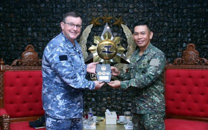 <p><strong>EXPANDING TIES.</strong> Maj. Gen. Noel Beleran, Armed Forces of the Philippines (AFP) deputy chief of staff for education, training and doctrine (right) hands over a token to Wing Commander Nicholas Pausina, head of the Australian Defense College delegation, during their meeting at AFP General Headquarters on Tuesday (Sept. 19, 2023). Pausina said the Australian Defense College is looking to expand its relationship with its Filipino counterparts. <em>(Photo courtesy of the AFP)</em></p>