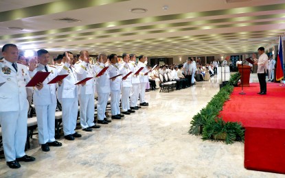 <p><strong>PROMOTED.</strong> President Ferdinand R. Marcos Jr. administers the oaths of office of newly promoted star rank offices of the Philippine National Police at the Heroes Hall of Malacañan Palace in Manila on Sept. 19, 2023. The President assured the police force of his administration’s continued support for its plans and programs aimed at improving the capabilities of its personnel. <em>(PNA photo by Rey Baniquet)</em></p>