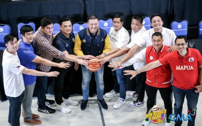 <p><strong>99th SEASON.</strong> Coaches of the participating basketball teams of the National Collegiate Athletic Association (NCAA) join hands during the launch of Season 99 NCAA at the MOA Arena lobby on Thursday (Sept. 21, 2023). Basketball actions will kick off on Sunday (Sept. 24). <em>(Photo courtesy of NCAA)</em></p>