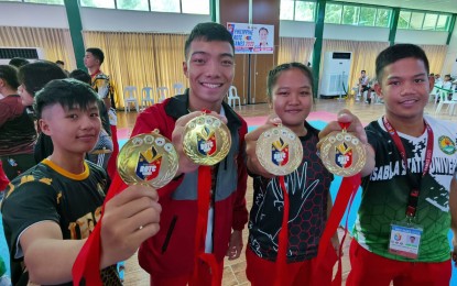 <p><strong>WINNERS.</strong> Philippine Navy cadets show their gold medals during the awarding ceremony of the Reserve Officers' Training Corps Games Luzon leg arnis competition at the International Convention Center inside the Cavite State University (CAVSU) Don Severino delas Alas campus in Indang, Cavite on Friday (September 22, 2023). From left are Avygail Ummas, Mikee Tungcul, Ronamae Rosquita and Hearnette Jade Arellano. <em>(PNA photo by Jean Malanum)</em></p>