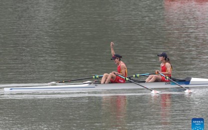 <p><strong>FIRST GOLD</strong>. Zou Jiaqi and Qiu Xiuping of China (left) celebrate after the women's lightweight double sculls final of rowing at the 19th Asian Games in Hangzhou, east China's Zhejiang Province on Sunday (Sept. 24, 2023). Zou Jiaqi and Qiu Xiuping claimed the first gold medal of the 19th Asian Games.<em> (Xinhua/Du Xiaoyi)</em></p>